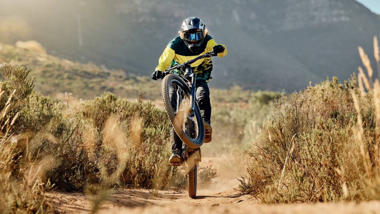 Mountain biker, dirt bike and dessert rider cycling on bmx bicycle on nature path, dirt road and ex